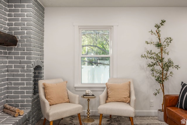 living area with brick wall