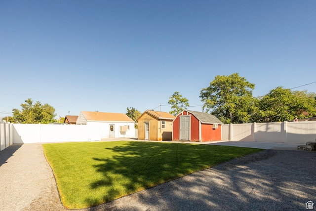 view of front of property featuring a front lawn, a shed, and a patio
