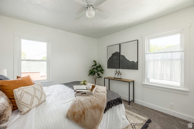 bedroom featuring carpet flooring, multiple windows, and ceiling fan
