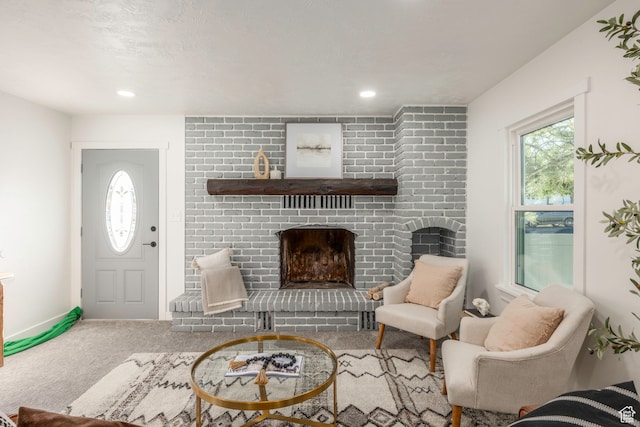 carpeted foyer with a fireplace and a textured ceiling