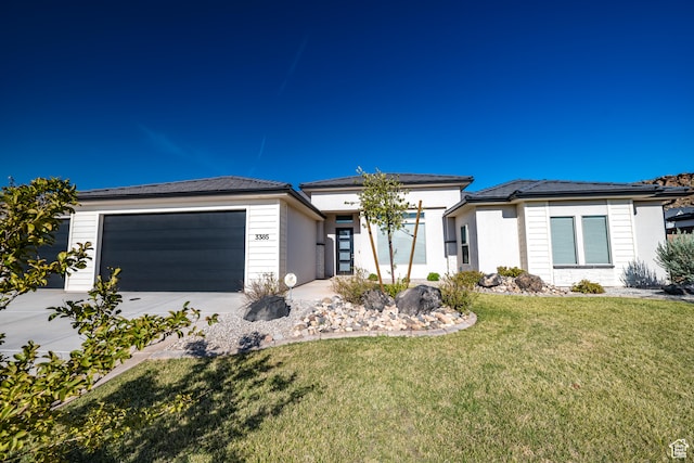 3385 S Marblewood Dr, St George, UT 84790 - view of front of home with a garage and a front lawn
