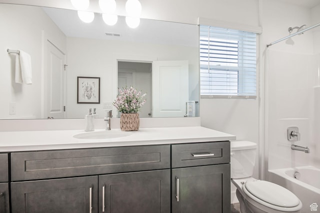 bathroom with vanity, toilet, washtub / shower combination, and visible vents