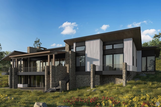 back of property with stone siding and stairs
