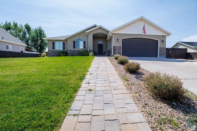 349 W 2900 S, Vernal, UT 84078 - view of front of property with fence, concrete driveway, a front lawn, a garage, and stone siding