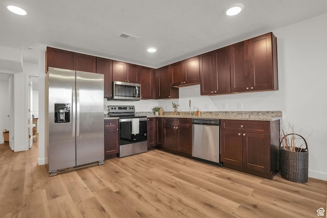 kitchen featuring recessed lighting, visible vents, light wood-style floors, and appliances with stainless steel finishes