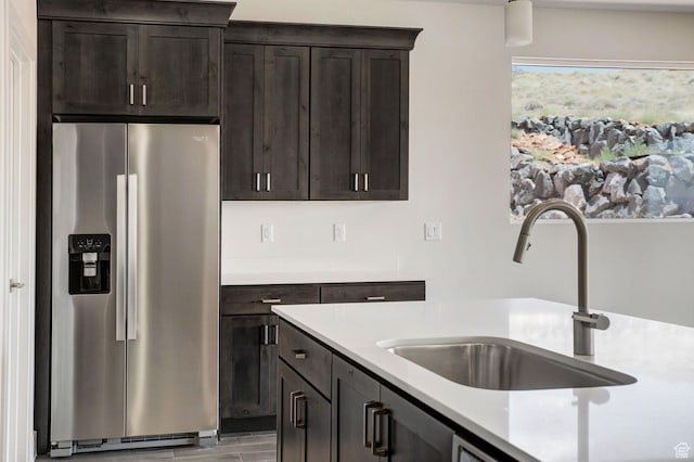 2128 N Montagna St, Washington, UT 84780 - kitchen with stainless steel refrigerator with ice dispenser, a sink, light countertops, light wood-type flooring, and dark brown cabinets