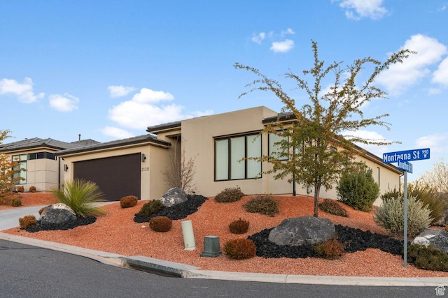 2128 N Montagna St, Washington, UT 84780 - view of front facade featuring an attached garage, driveway, and stucco siding