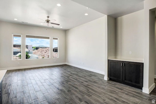 2128 N Montagna St, Washington, UT 84780 - unfurnished living room featuring visible vents, baseboards, dark wood-style flooring, ceiling fan, and recessed lighting