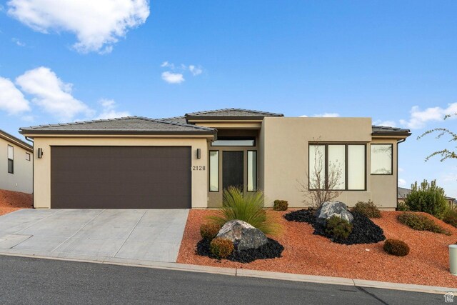 2128 N Montagna St, Washington, UT 84780 - prairie-style home featuring a tiled roof, driveway, a garage, and stucco siding