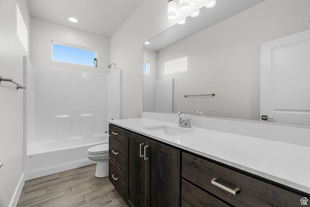 2128 N Montagna St, Washington, UT 84780 - full bath with washtub / shower combination, baseboards, toilet, vanity, and wood finished floors