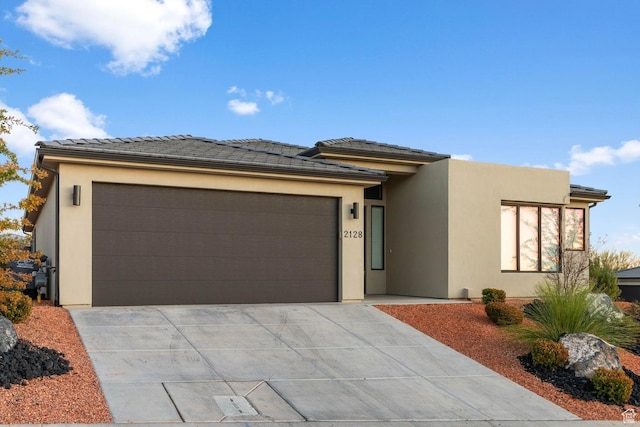 2128 N Montagna St, Washington, UT 84780 - view of front of house with concrete driveway, stucco siding, and an attached garage