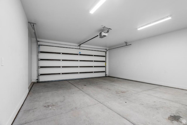 2128 N Montagna St, Washington, UT 84780 - garage featuring a garage door opener and baseboards