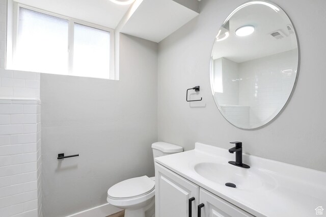 2745 Grant Ave, Ogden, UT 84401 - bathroom featuring baseboards, visible vents, toilet, and vanity