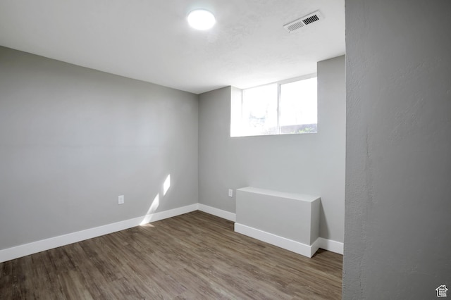2745 Grant Ave, Ogden, UT 84401 - below grade area with baseboards, visible vents, and wood finished floors