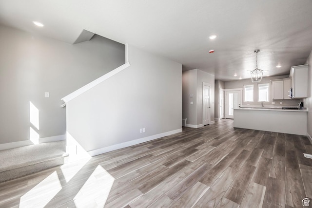 1082 S 2810 E, Spanish Fork, UT 84660 - unfurnished living room with baseboards, recessed lighting, and light wood-style floors