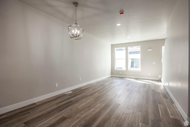 1082 S 2810 E, Spanish Fork, UT 84660 - empty room featuring a chandelier, dark wood-type flooring, visible vents, and baseboards