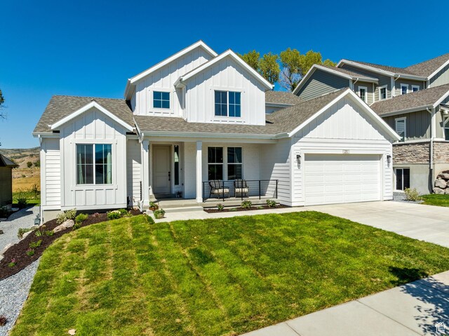 291 E 1980 N, Heber City, UT 84032 - modern farmhouse featuring covered porch, a garage, concrete driveway, board and batten siding, and a front yard