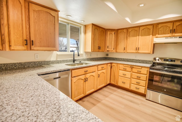 265 E Center St, Beaver, UT 84713 - kitchen with light wood-style flooring, under cabinet range hood, stainless steel appliances, a sink, and light stone countertops