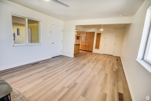 265 E Center St, Beaver, UT 84713 - unfurnished living room featuring light wood-style floors, baseboards, visible vents, and a ceiling fan