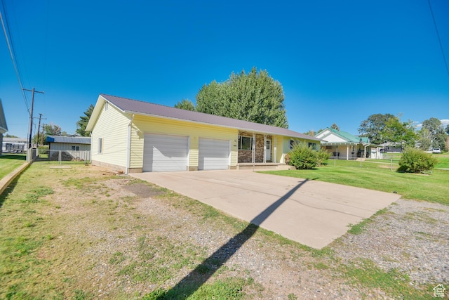 265 E Center St, Beaver, UT 84713 - ranch-style home featuring metal roof, an attached garage, fence, concrete driveway, and a front yard