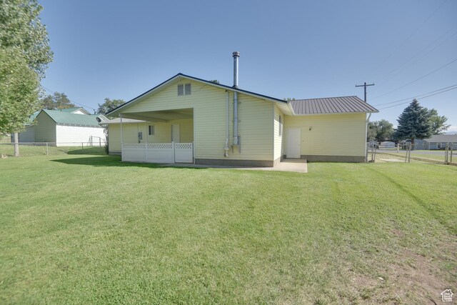 265 E Center St, Beaver, UT 84713 - back of property featuring fence, metal roof, and a yard