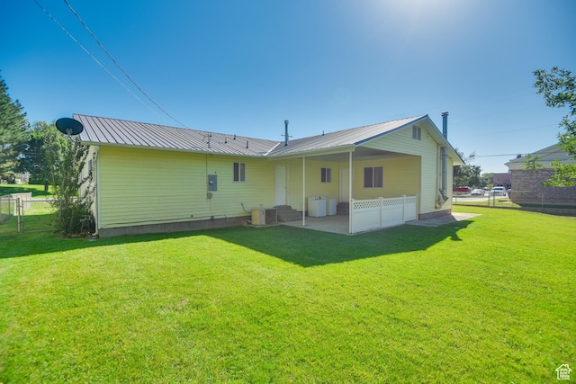 265 E Center St, Beaver, UT 84713 - rear view of property with central air condition unit, fence, metal roof, and a yard