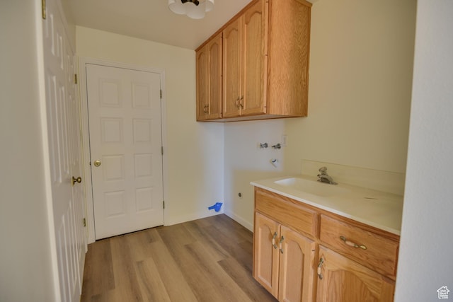 265 E Center St, Beaver, UT 84713 - clothes washing area with cabinet space, a sink, light wood-style floors, washer hookup, and electric dryer hookup