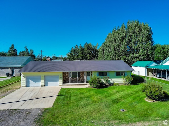 265 E Center St, Beaver, UT 84713 - ranch-style house with an attached garage, driveway, a front lawn, and metal roof