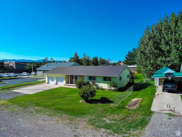 265 E Center St, Beaver, UT 84713 - ranch-style house with concrete driveway, a front yard, metal roof, fence, and a garage