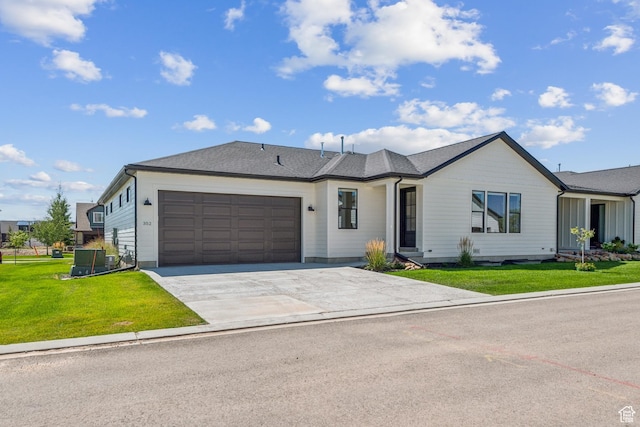 single story home with driveway, a shingled roof, a garage, and a front lawn