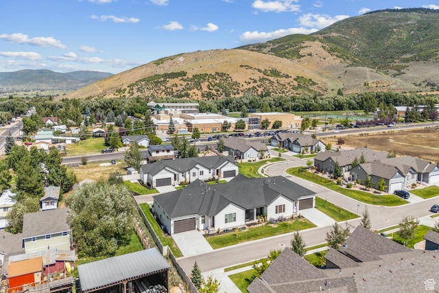 birds eye view of property with a mountain view and a residential view
