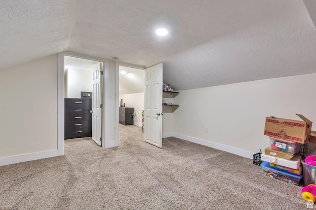 22 W 200 S, Tooele, UT 84074 - additional living space featuring a textured ceiling, baseboards, lofted ceiling, and carpet floors