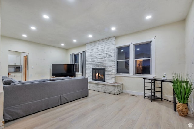 22 W 200 S, Tooele, UT 84074 - living room featuring baseboards, recessed lighting, wood finished floors, and a fireplace