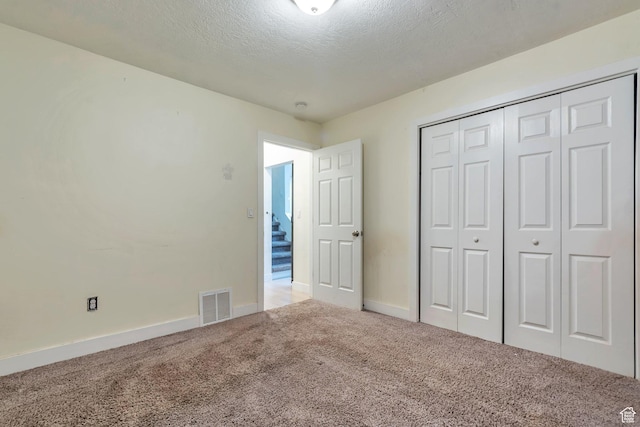 22 W 200 S, Tooele, UT 84074 - unfurnished bedroom featuring a textured ceiling, a closet, visible vents, carpet flooring, and baseboards