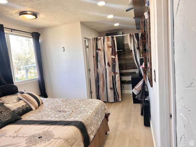 22 W 200 S, Tooele, UT 84074 - bedroom featuring light wood-type flooring and a textured ceiling