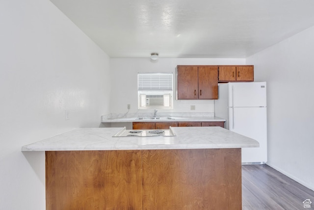 535 N 700 E Unit 1-4, Spanish Fork, UT 84660 - kitchen featuring freestanding refrigerator, a sink, brown cabinets, a peninsula, and wood finished floors