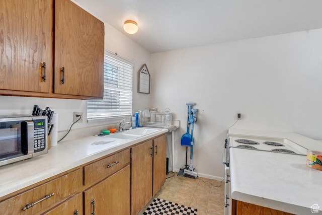 535 N 700 E Unit 1-4, Spanish Fork, UT 84660 - kitchen featuring stainless steel microwave, a sink, light countertops, and brown cabinetry