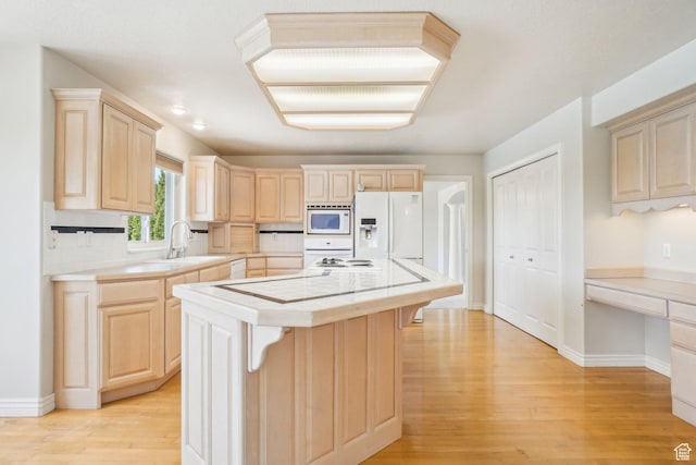 678 Eagle Way, Fruit Heights, UT 84037 - kitchen with light countertops, light brown cabinetry, and white appliances
