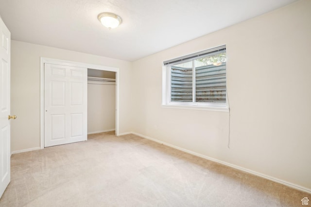 678 Eagle Way, Fruit Heights, UT 84037 - unfurnished bedroom with a closet, baseboards, and light carpet