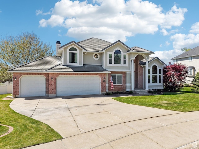 678 Eagle Way, Fruit Heights, UT 84037 - view of front of house with a chimney, fence, a front lawn, driveway, and brick siding
