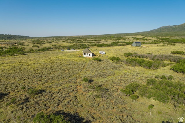 birds eye view of property with a rural view
