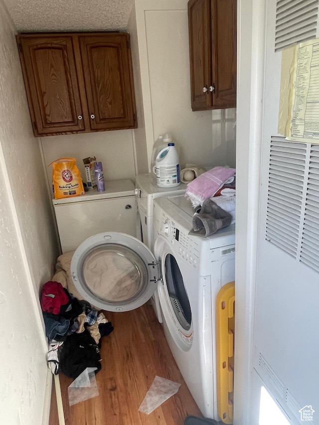 3772 N 15530 W, Altamont, UT 84001 - laundry room with wood finished floors, cabinet space, and washer and clothes dryer