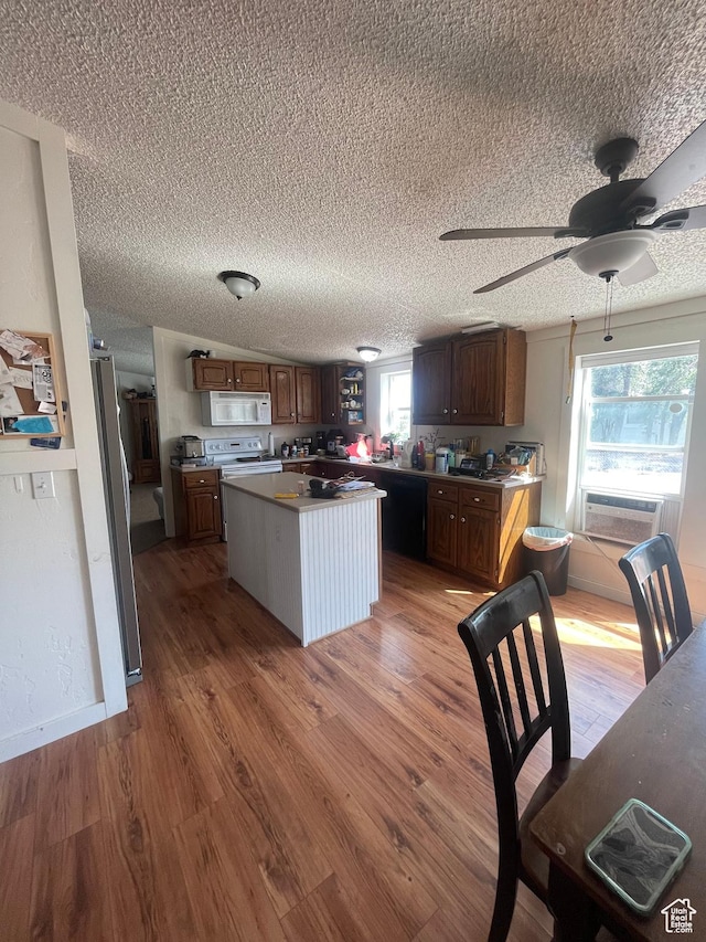 3772 N 15530 W, Altamont, UT 84001 - kitchen with a center island, ceiling fan, white appliances, a textured ceiling, and light wood-style flooring