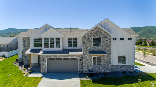 view of front facade featuring a mountain view, a garage, and a front yard