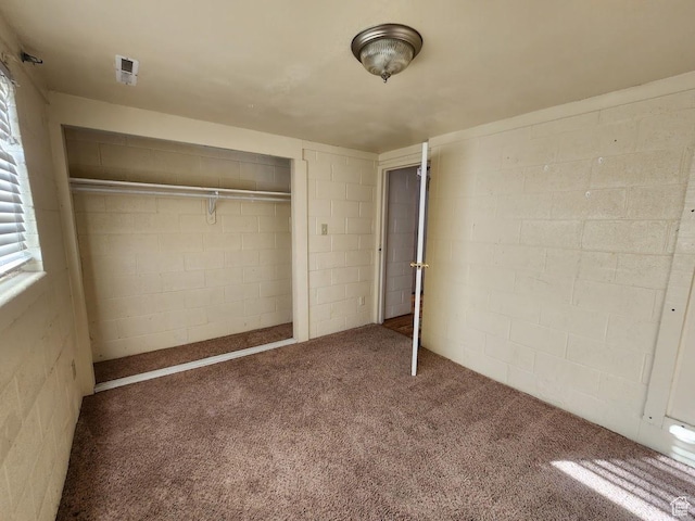 370 W 620 N, Castle Dale, UT 84513 - unfurnished bedroom featuring a closet, concrete block wall, and carpet