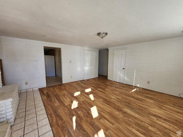 370 W 620 N, Castle Dale, UT 84513 - interior space with concrete block wall, light wood-type flooring, and a textured ceiling