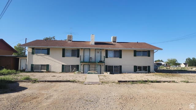 370 W 620 N, Castle Dale, UT 84513 - rear view of property with stairs, central air condition unit, brick siding, and a chimney