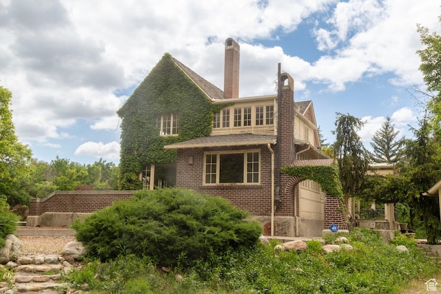 2633 E 6200 S, Holladay, UT 84121 - back of property with brick siding, a chimney, and an attached garage