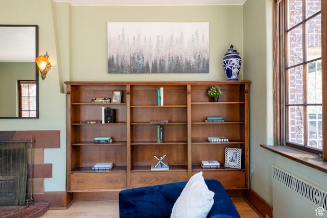 2633 E 6200 S, Holladay, UT 84121 - sitting room featuring radiator heating unit, wood finished floors, baseboards, and a fireplace with raised hearth