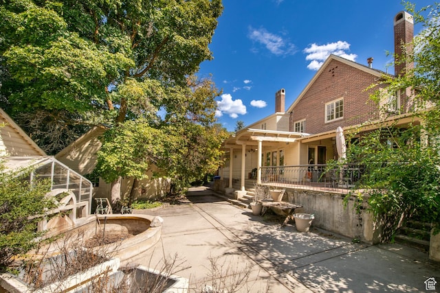 2633 E 6200 S, Holladay, UT 84121 - back of house with a patio area, a chimney, brick siding, and a pergola